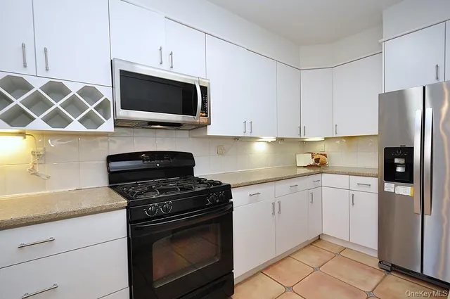a kitchen with stainless steel appliances a stove a microwave and sink