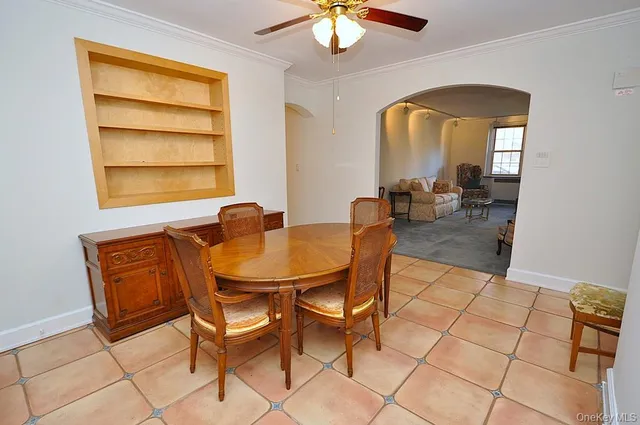 a view of a dining room with furniture and a window