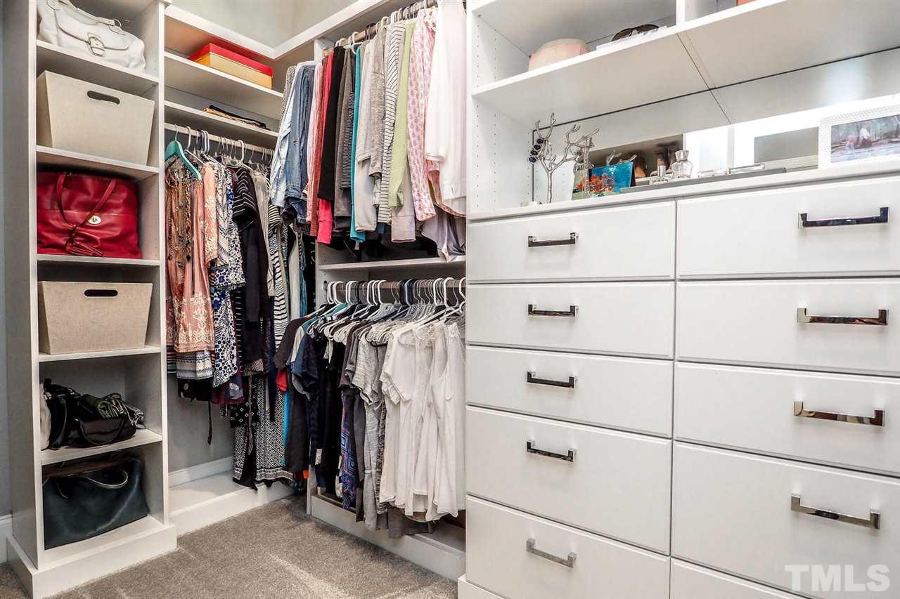 5005 Rampart Street Raleigh, NC 27609 - Photo 14 of 25 a view of walk in closet with clothes and shoes