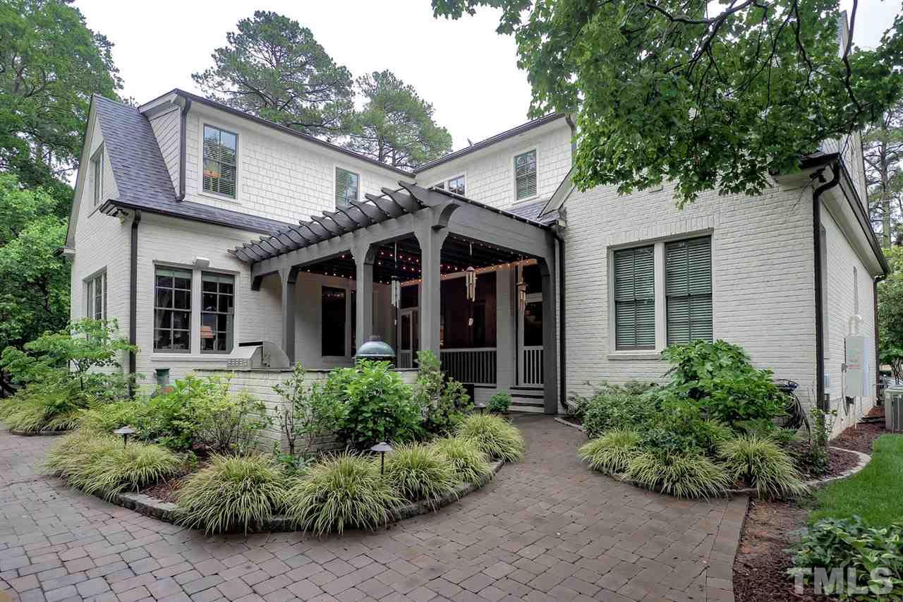 5005 Rampart Street Raleigh, NC 27609 - Photo 23 of 25 front view of a house with a lots of potted plants