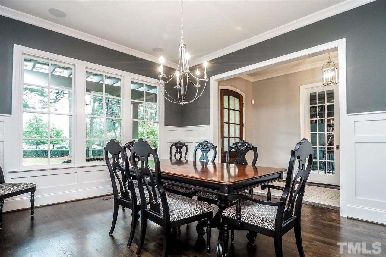 5005 Rampart Street Raleigh, NC 27609 - Photo 4 of 25 a view of a dining room with furniture window and wooden floor
