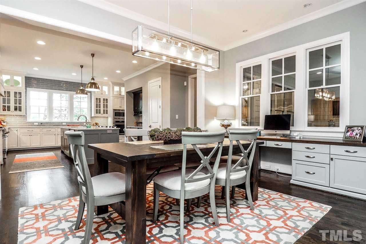 5005 Rampart Street Raleigh, NC 27609 - Photo 8 of 25 a dining area with a table chairs and a kitchen view