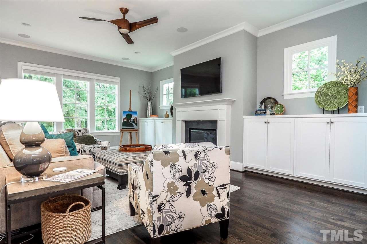 5005 Rampart Street Raleigh, NC 27609 - Photo 10 of 25 a living room with furniture a fireplace and a flat screen tv