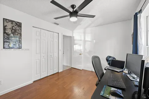 a view of a workspace with furniture and a flat screen tv