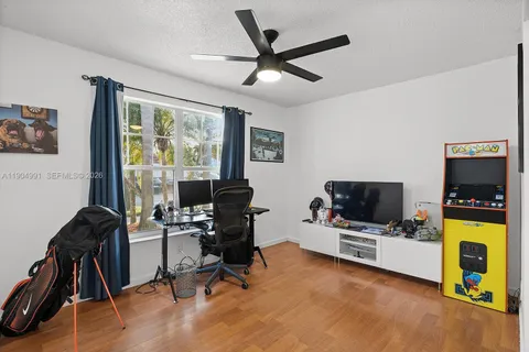a view of workspace with furniture and flat screen tv