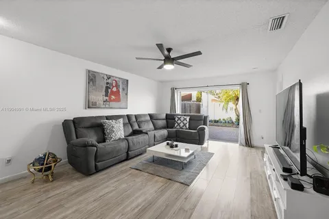 a living room with furniture wooden floor and a flat screen tv