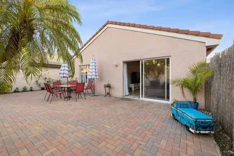 a view of a house with a patio and a yard