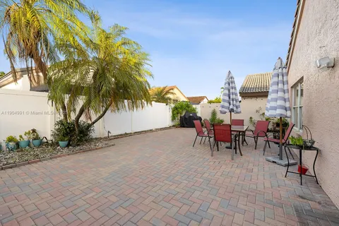 a view of a house with a patio and a yard