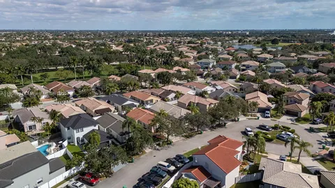 an aerial view of a house with a garden and trees