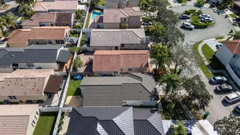 a view of a swimming pool with a patio and wooden floor