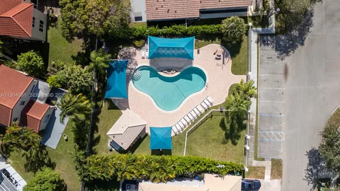 a view of a swimming pool with a patio and wooden floor