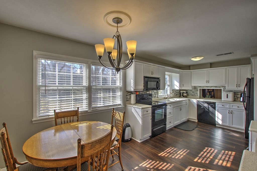 2261 Hoyt Court Decatur, IL 62526 - Photo 9 of 26 a kitchen with sink refrigerator dining table and chairs