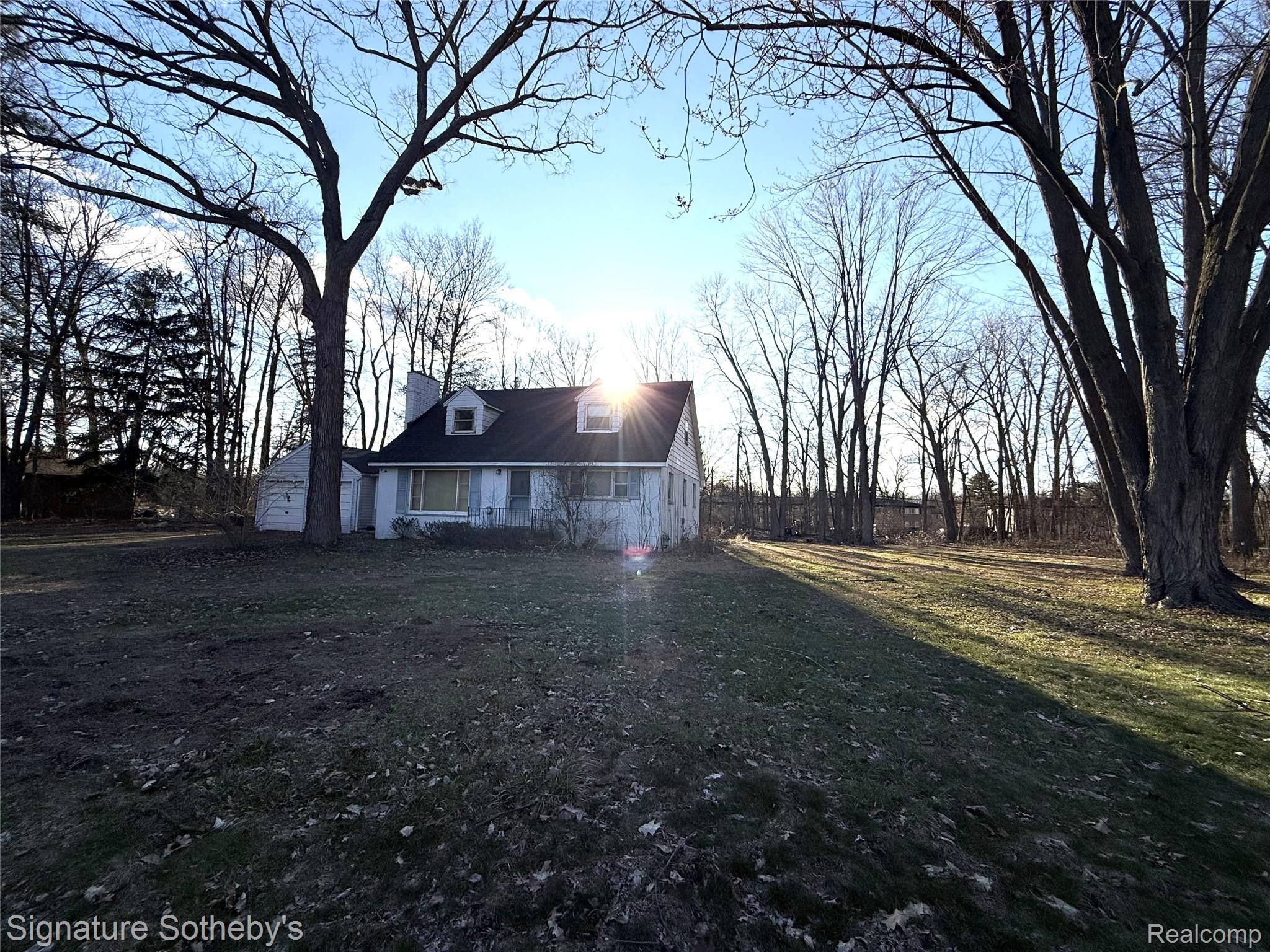 5825 North Lotz Road Canton, MI 48187 - Photo 1 of 10 View of front of home featuring an outdoor structure, a front yard, and a chimney
