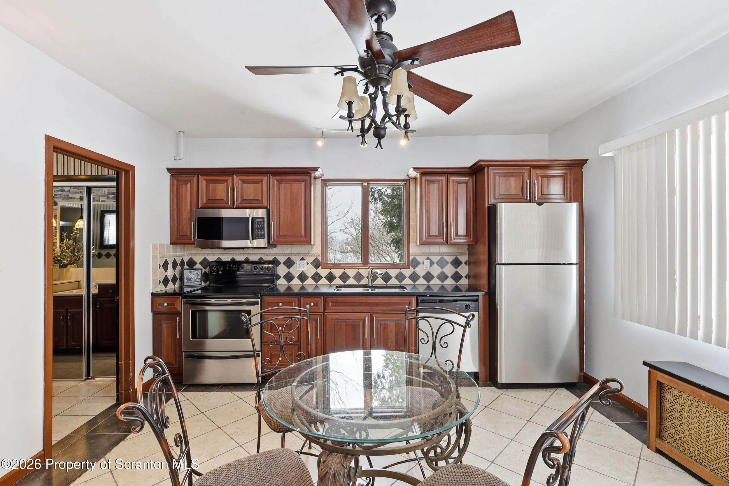 143 Old Boston Road Pittston, PA 18640 - Photo 39 of 61 a kitchen with stainless steel appliances granite countertop a refrigerator a stove top oven a kitchen island a dining table and chairs