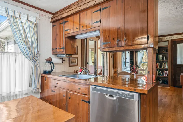 a kitchen with stainless steel appliances granite countertop a sink and a cabinets