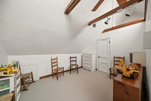 a bedroom with bed and a chandelier