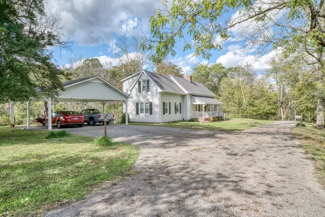 a bathroom with a sink a toilet a mirror and shower curtain
