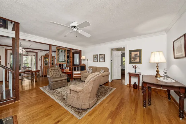 a living room with furniture and a wooden floor