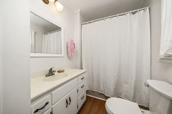 a bedroom with a bed and dresser