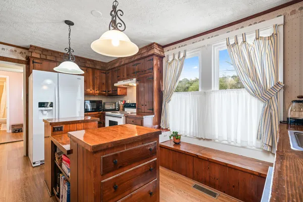 a kitchen with stainless steel appliances a stove a refrigerator and a microwave