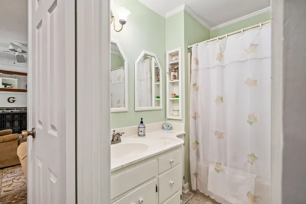 a bathroom with a double vanity sink a mirror a shower and vanity