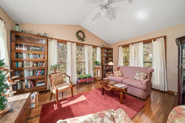 a living room with furniture and a floor to ceiling window