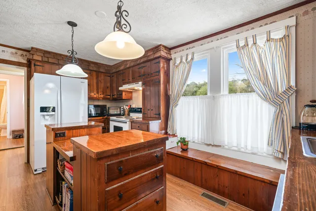 a kitchen with stainless steel appliances a stove a refrigerator and a microwave