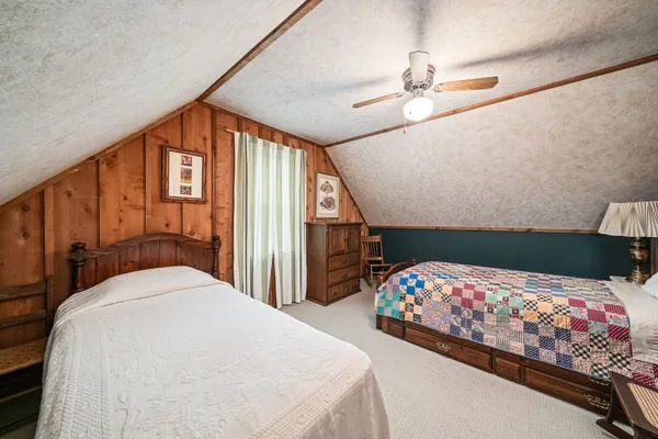 a bedroom with bed and a chandelier