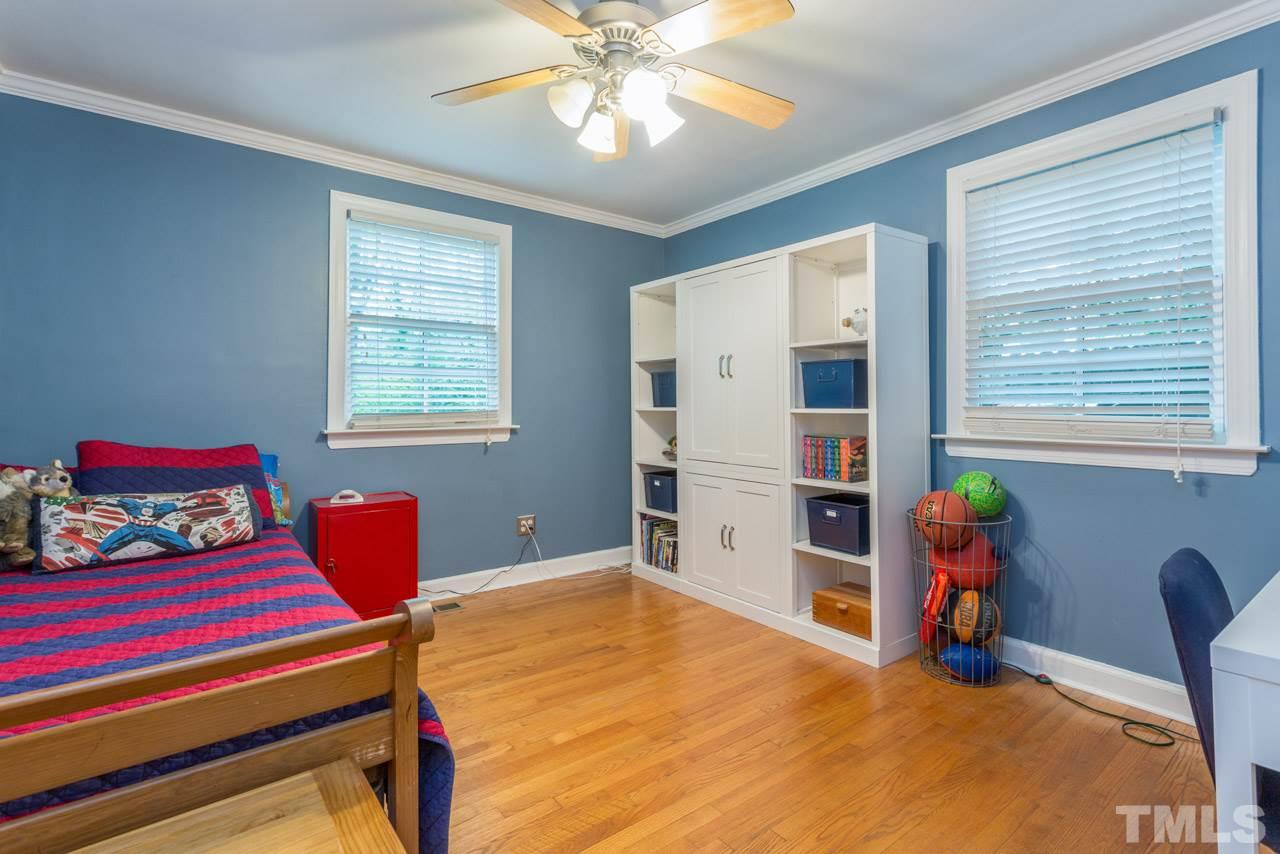 319 Furches Street Raleigh, NC 27607 - Photo 12 of 25 a bedroom with a bed and a window