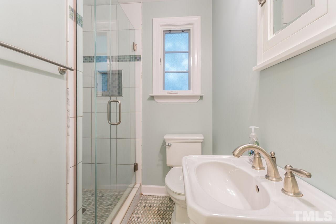 319 Furches Street Raleigh, NC 27607 - Photo 13 of 25 a bathroom with a sink and shower