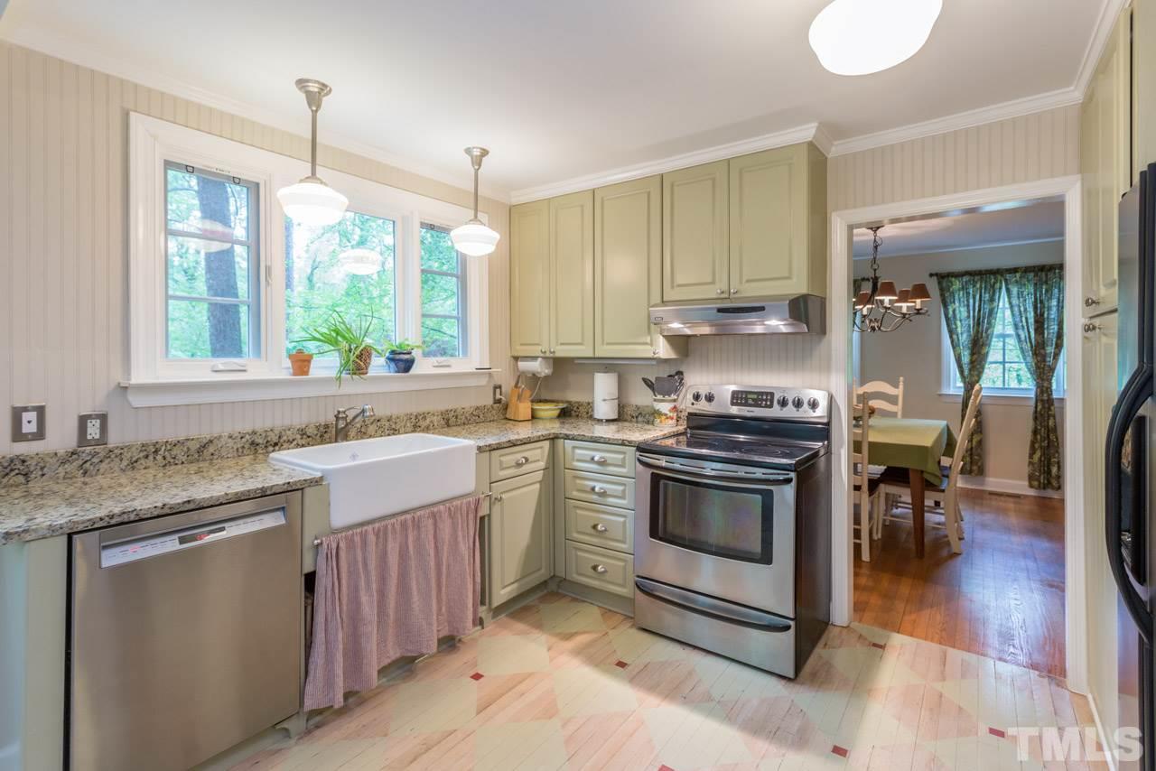 319 Furches Street Raleigh, NC 27607 - Photo 14 of 25 a kitchen with stainless steel appliances granite countertop a stove a sink and a microwave