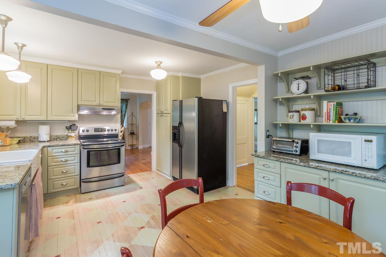 319 Furches Street Raleigh, NC 27607 - Photo 17 of 25 a kitchen with stainless steel appliances kitchen island granite countertop a refrigerator and a stove top oven