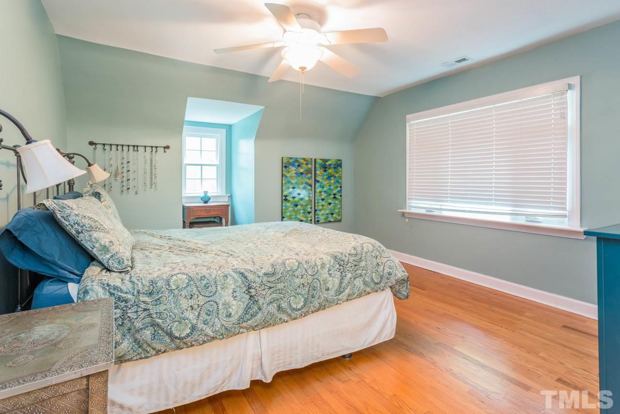 319 Furches Street Raleigh, NC 27607 - Photo 18 of 25 a bed sitting in a bedroom next to a window