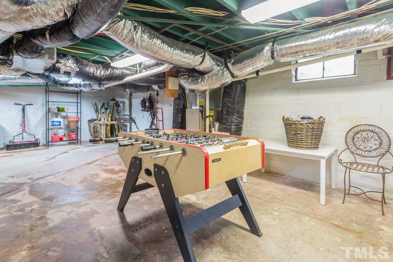 319 Furches Street Raleigh, NC 27607 - Photo 24 of 25 a view of a kitchen with a table and chairs