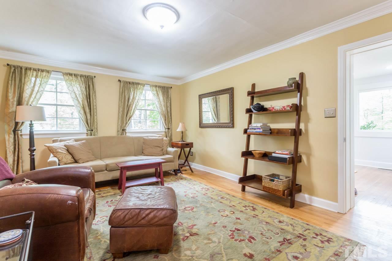 319 Furches Street Raleigh, NC 27607 - Photo 8 of 25 a living room with furniture a rug and a window