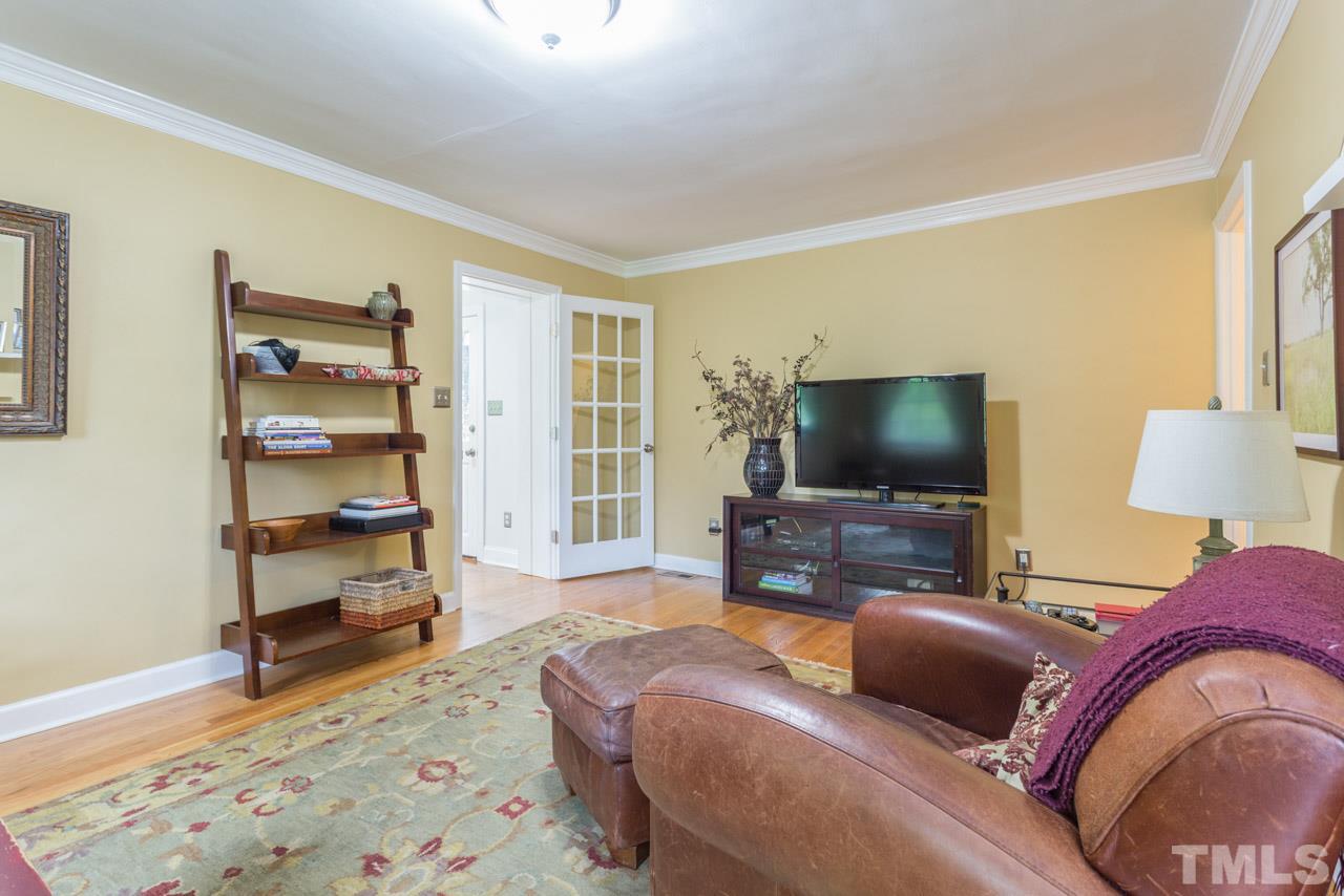 319 Furches Street Raleigh, NC 27607 - Photo 9 of 25 a living room with furniture and a flat screen tv