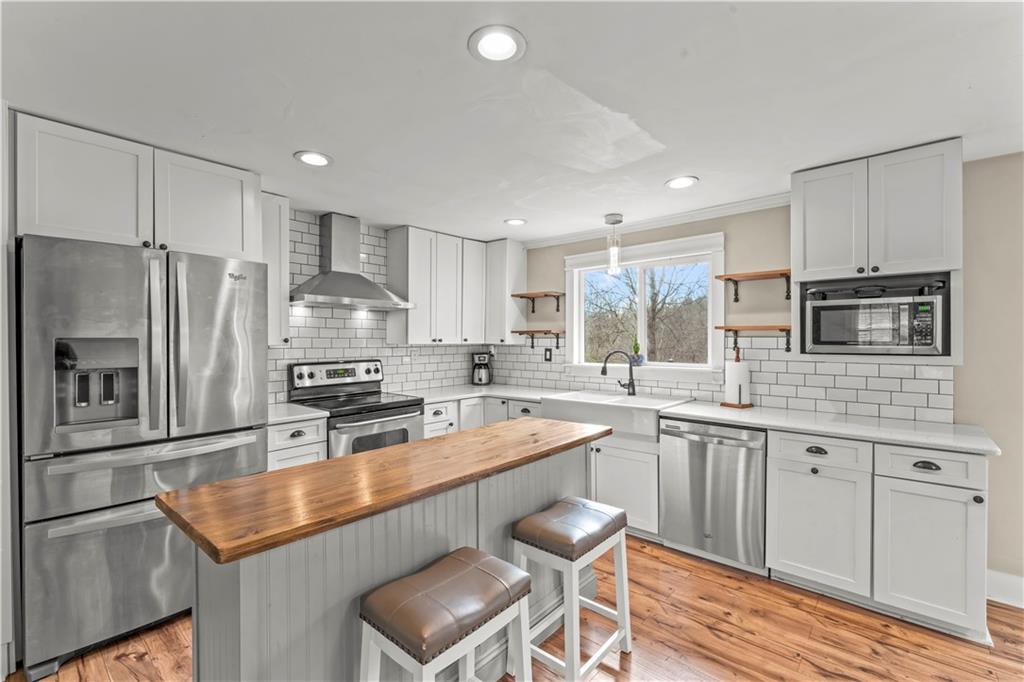 359 Hunting Creek Road Canonsburg, PA 15317 - Photo 13 of 39 a kitchen with stainless steel appliances granite countertop a sink stove refrigerator and cabinets