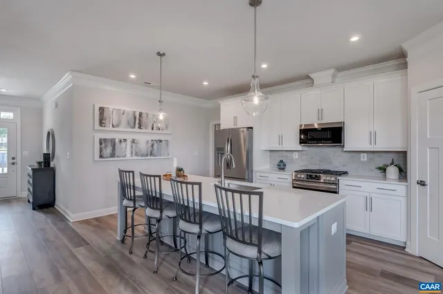 a spacious en suite bathroom with a granite countertop sink mirror and shower