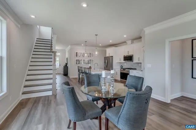a living room with furniture a wooden floor and a rug