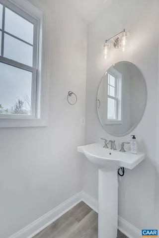 a kitchen with stainless steel appliances white cabinets and a stove a refrigerator with wooden floors