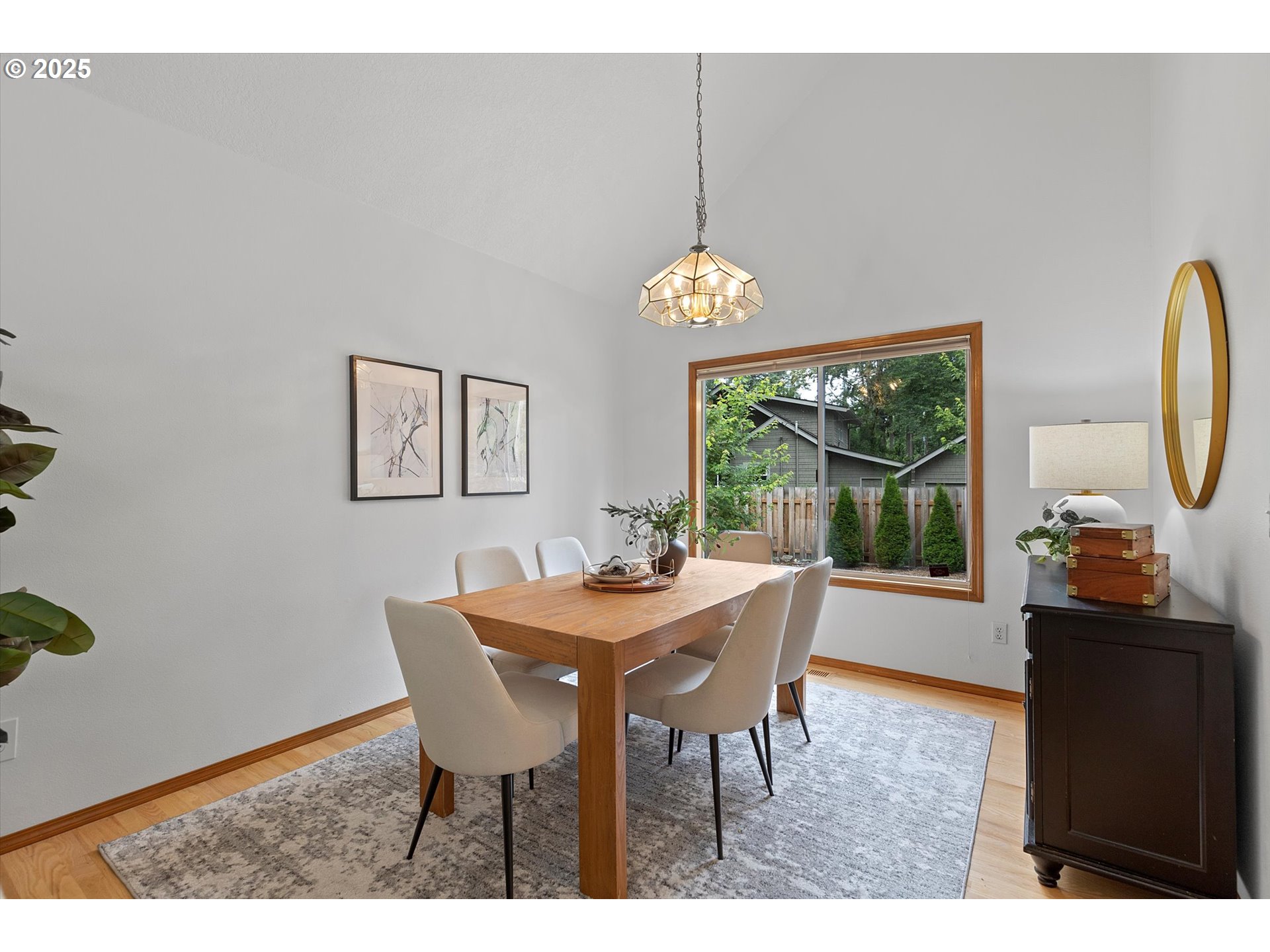 3475 Upper Drive Lake Oswego, OR 97035 - Photo 6 of 44 a dining room with furniture a chandelier and wooden floor