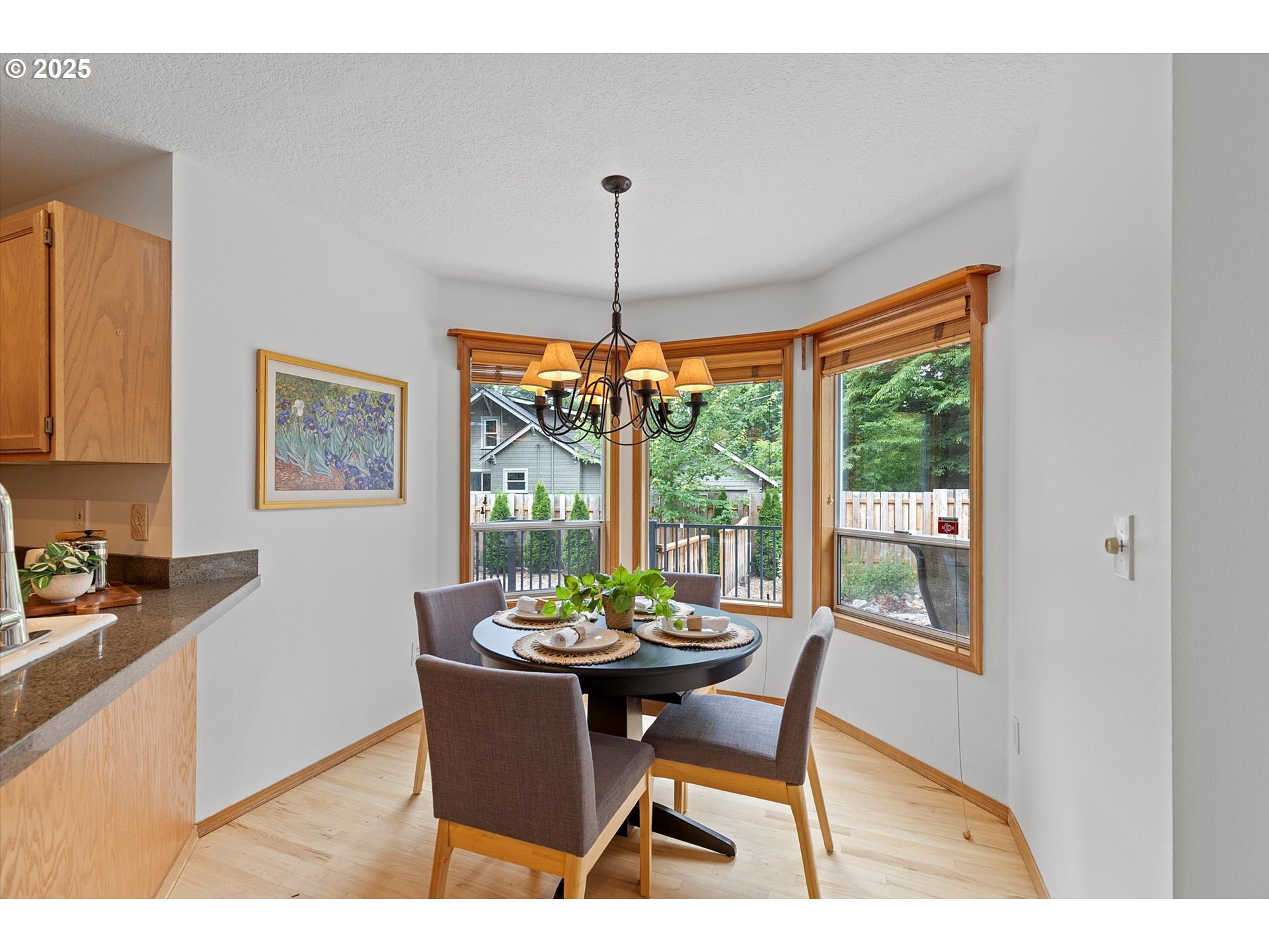 3475 Upper Drive Lake Oswego, OR 97035 - Photo 10 of 44 a dining room with furniture a chandelier and wooden floor