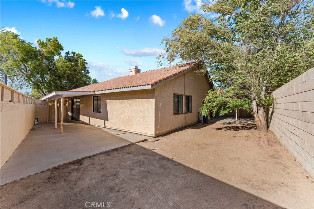 3542 East Ave R 10 Palmdale, CA 93550 - Photo 29 of 35 a view of a house with a yard and garage
