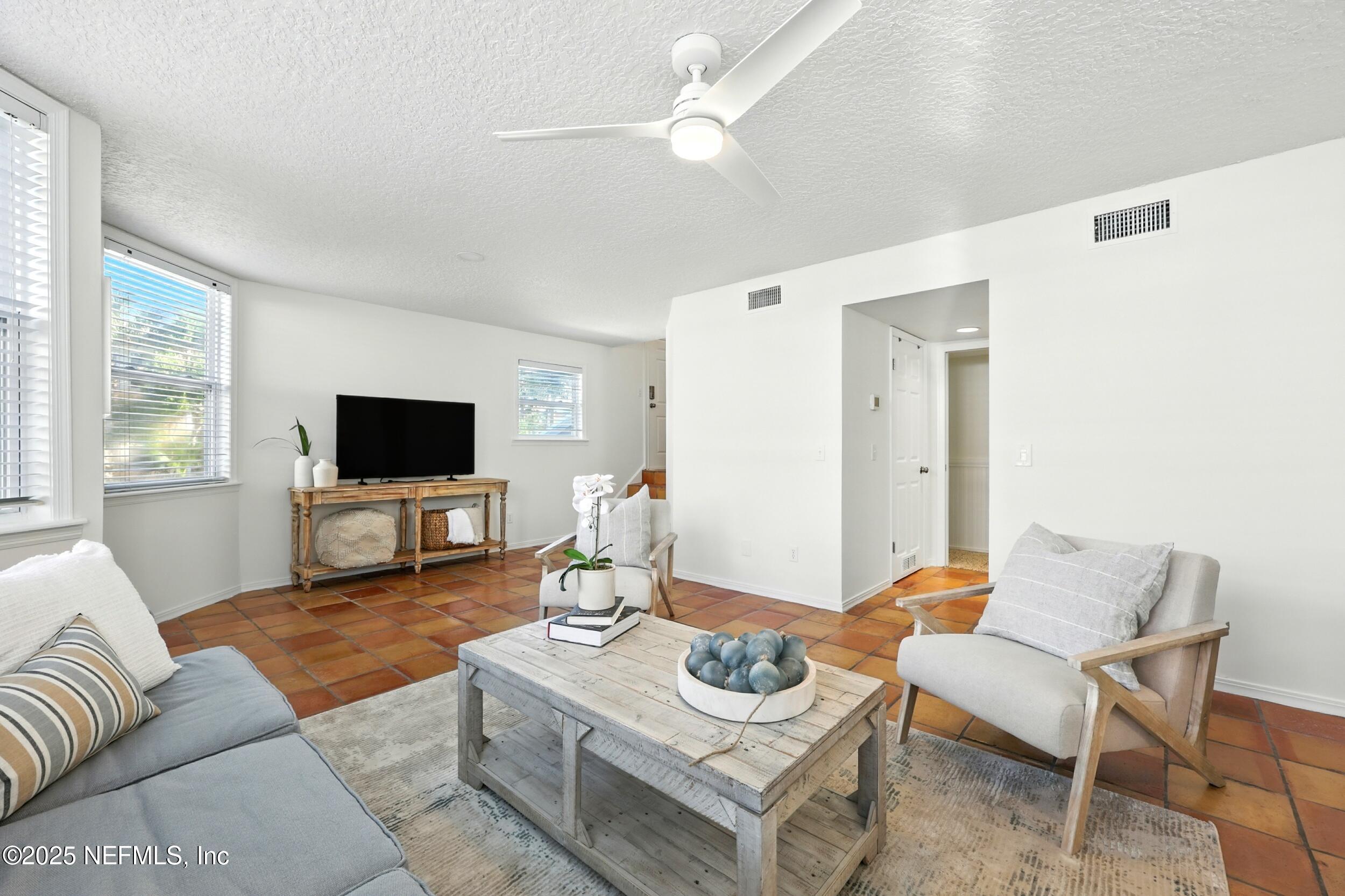 600 First Street Neptune Beach, FL 32266 - Photo 11 of 80 a living room with furniture and a flat screen tv