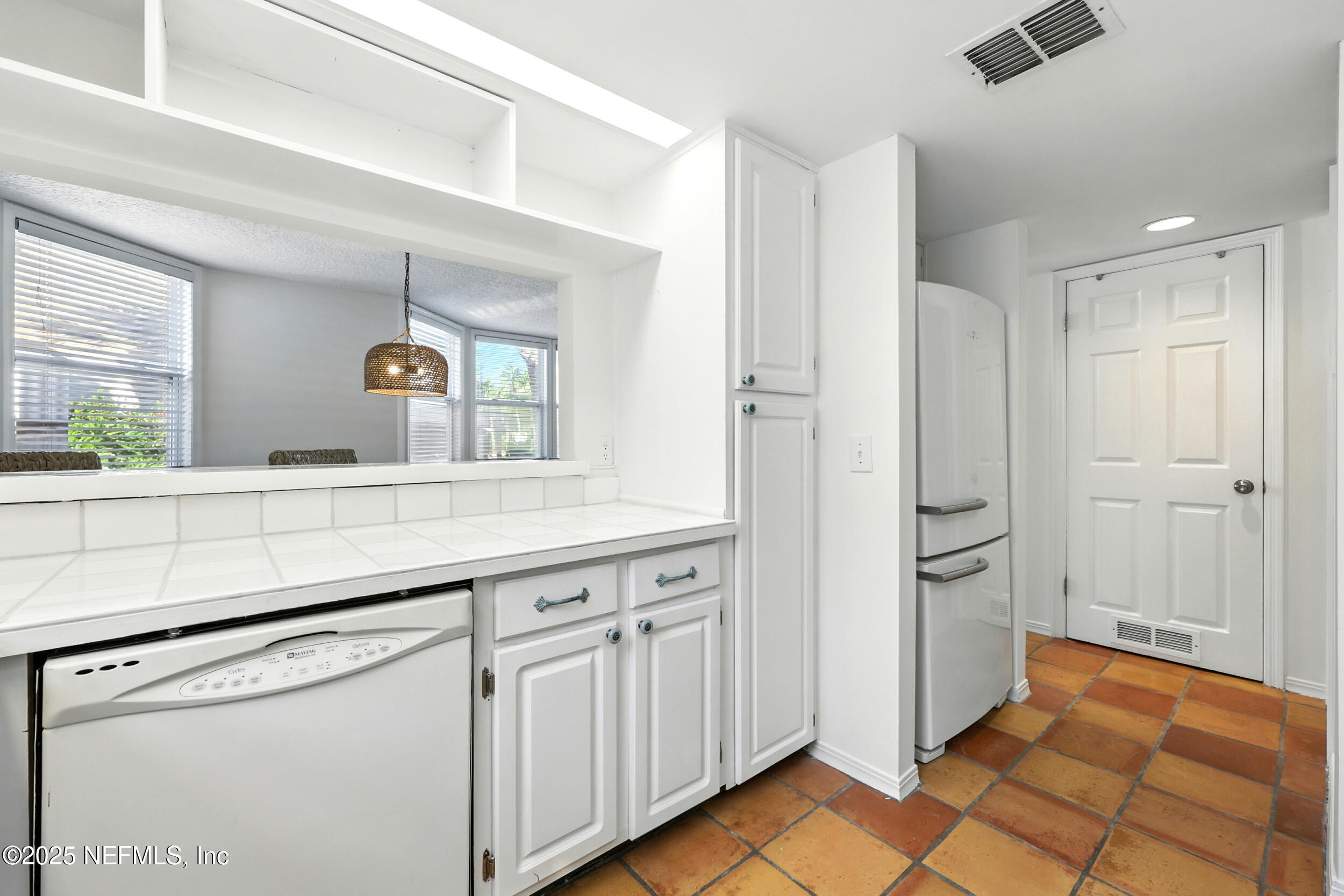 600 First Street Neptune Beach, FL 32266 - Photo 21 of 80 a kitchen with white cabinets and sink