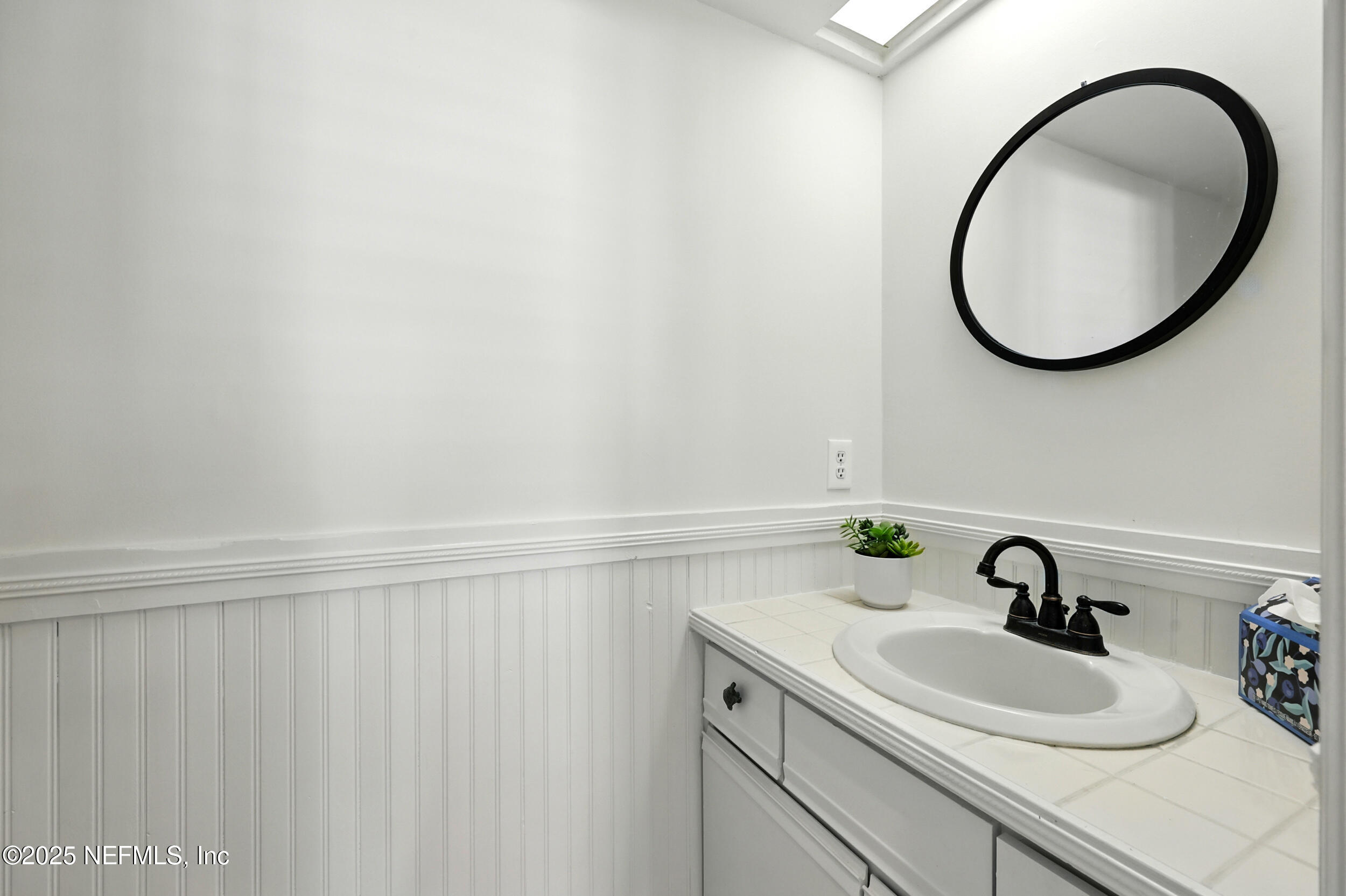 600 First Street Neptune Beach, FL 32266 - Photo 23 of 80 a bathroom with a sink and a mirror