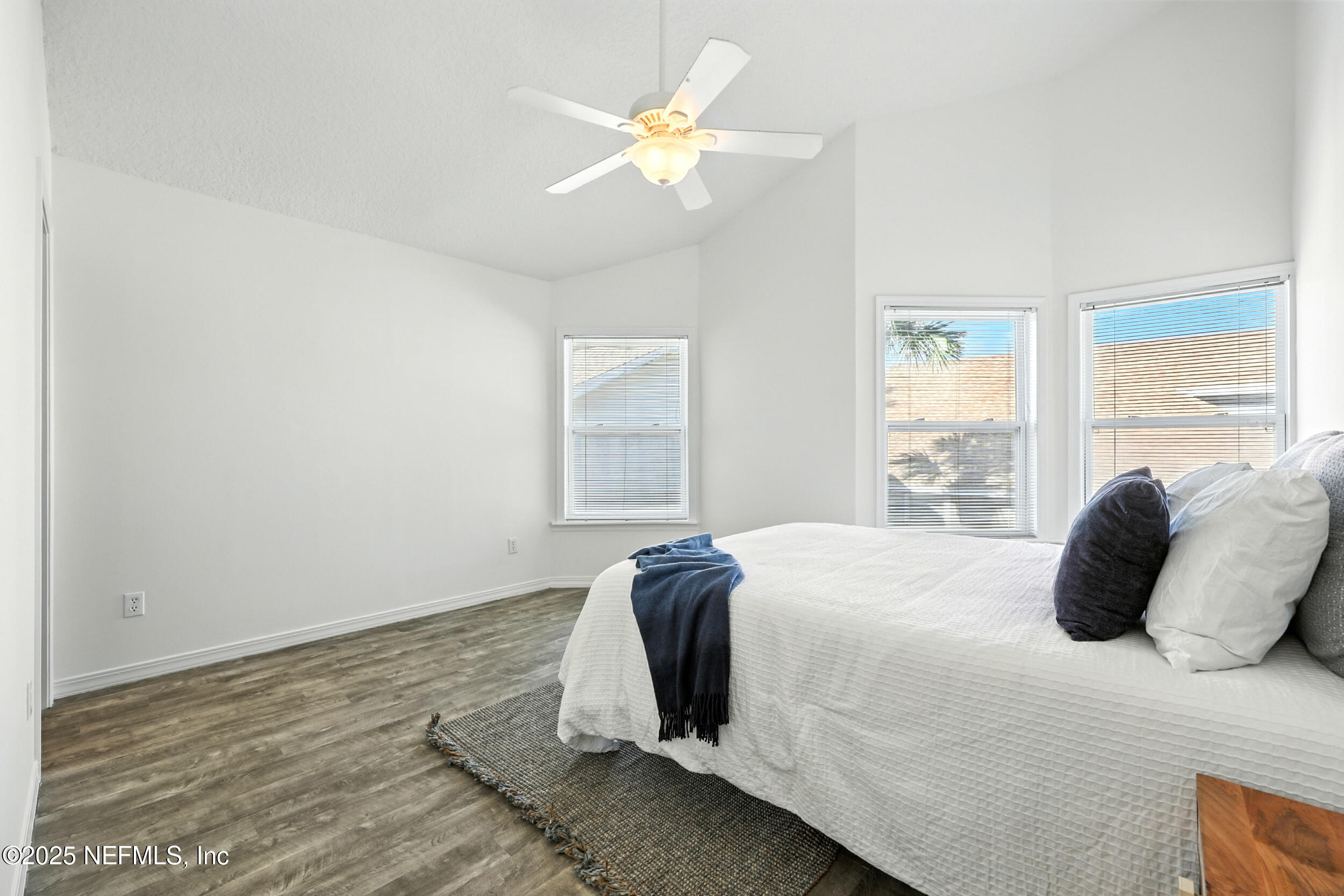 600 First Street Neptune Beach, FL 32266 - Photo 29 of 80 a bedroom with a bed and a chandelier