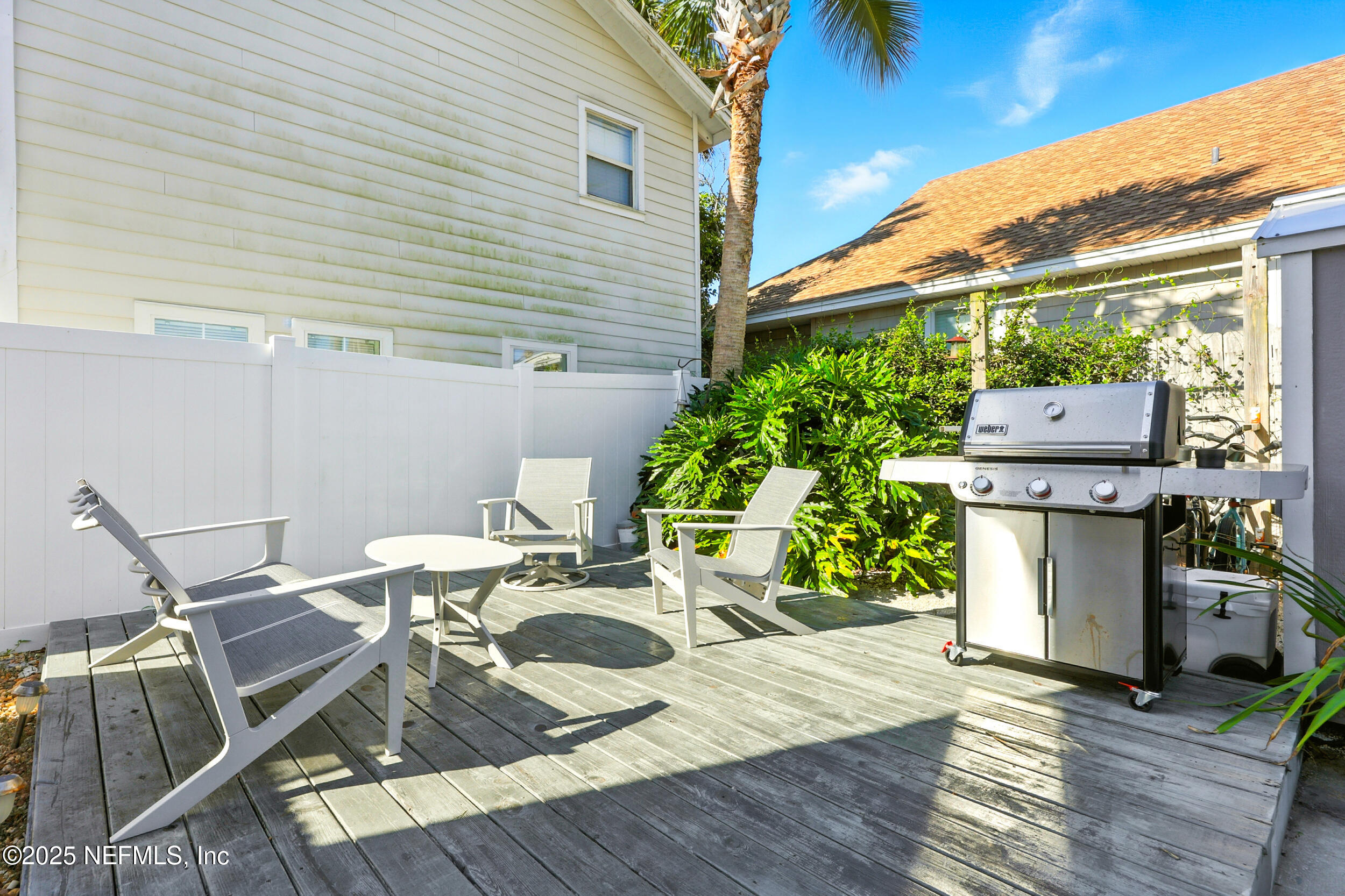 600 First Street Neptune Beach, FL 32266 - Photo 45 of 80 a view of a patio with table and chairs with wooden floor and plants