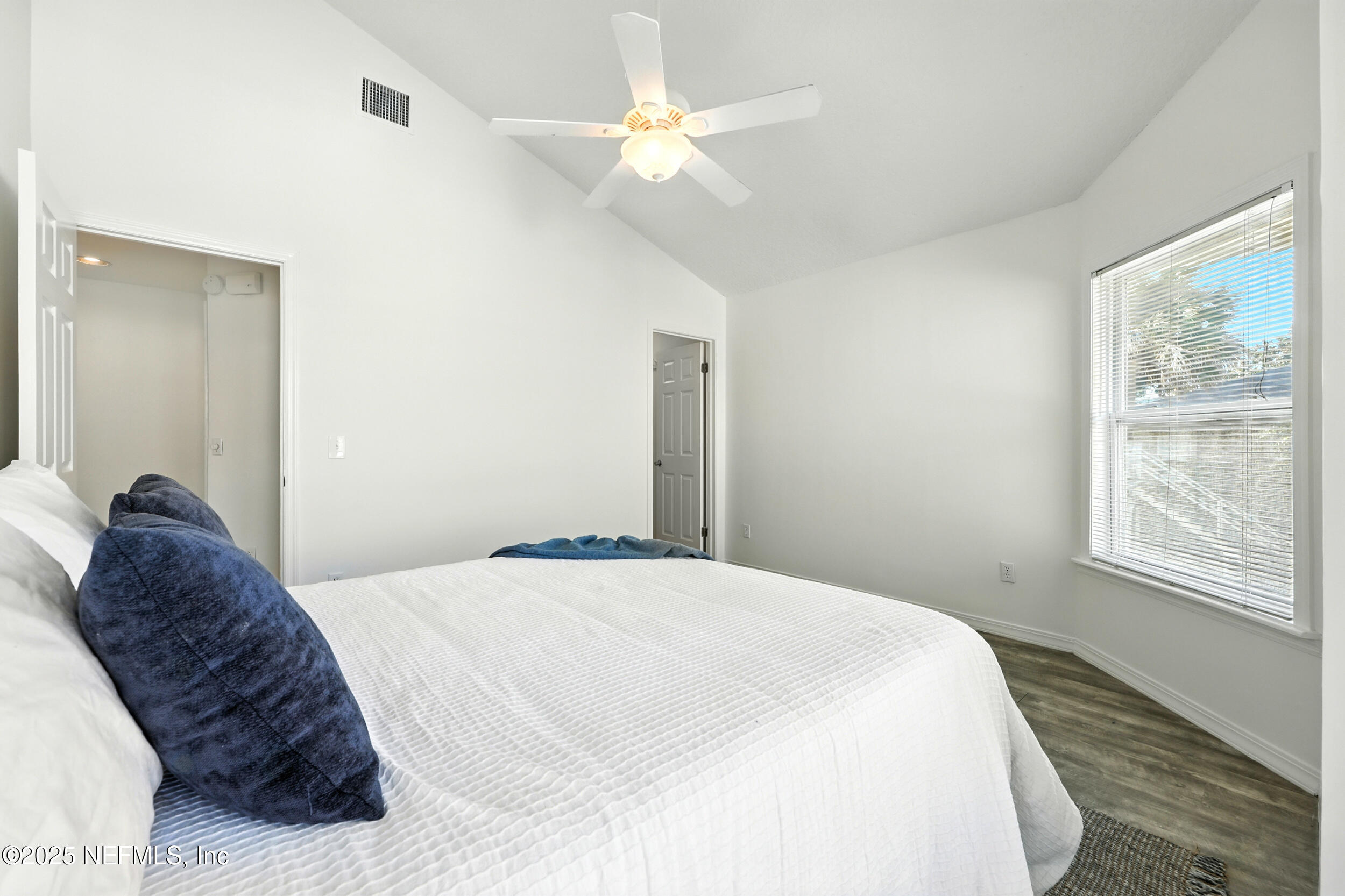 600 First Street Neptune Beach, FL 32266 - Photo 8 of 80 a bedroom with a large bed and a chandelier