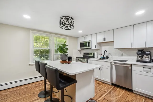 a kitchen with a table chairs and a refrigerator